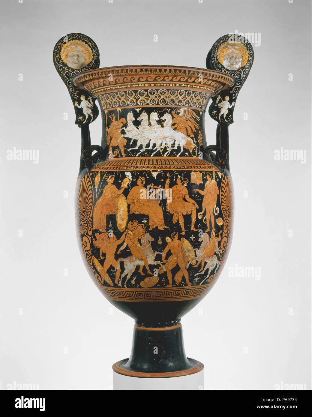 Terracotta volute-krater (vase for mixing wine and water). Culture: Greek, South Italian, Apulian. Dimensions: H. without handles: 36 1/16 in. (91.59 cm). Date: ca. 320-310 B.C..  On the body, obverse, assembly of gods above Amazonomachy  Reverse, youth in naiskos (shrine) between youths and women  On the neck, obverse, woman with torches leading Nike in chariot  On the handles, heads of Io and young Pans  The Capodimonte Painter was a follower of the Baltimore Painter, one of the most prolific late Apulian artists. Although they produced vases of diverse shapes and  sizes, these artists are a Stock Photo