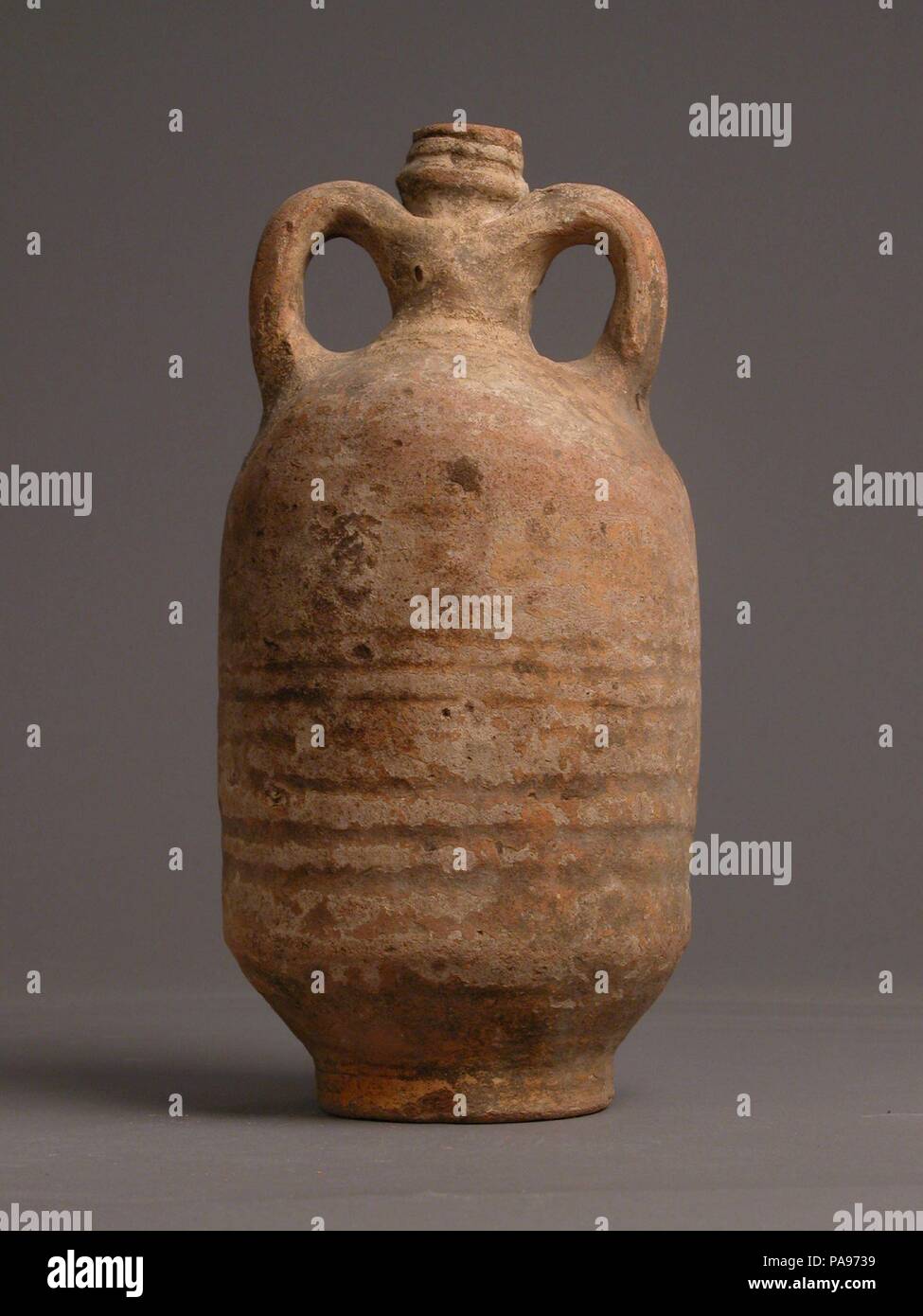 Jug. Culture: Coptic. Dimensions: Overall: 9 7/16 x 4 5/8 in. (23.9 x 11.7 cm). Date: 4th-7th century. Museum: Metropolitan Museum of Art, New York, USA. Stock Photo