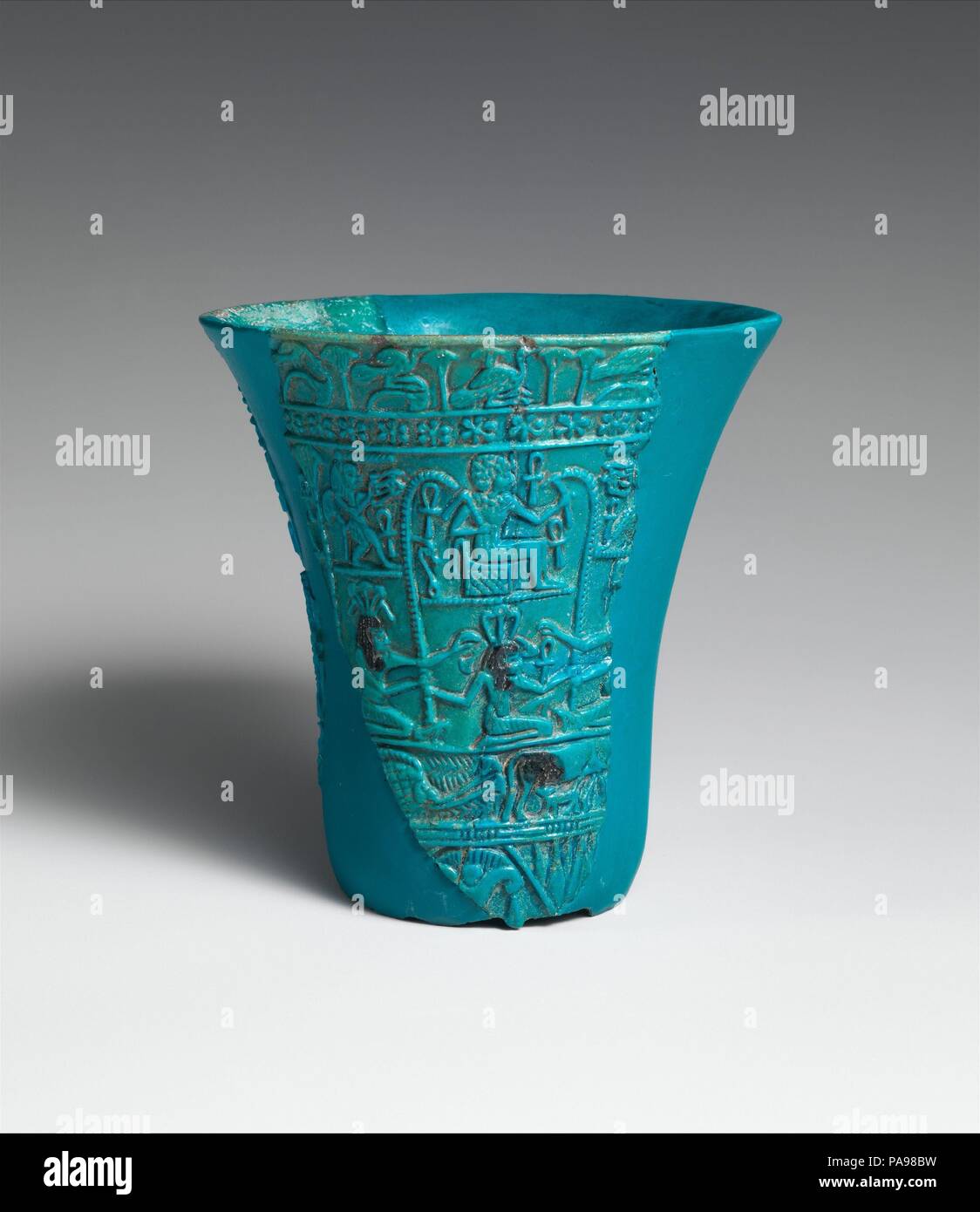 Reconstructed lotiform chalice. Dimensions: As reconstructed: H. 9.9 cm (3 7/8 in.); Diam. 9.3 cm (3 11/16 in.). Dynasty: Dynasty 21-25. Date: ca. 1070-664 B.C..  Made of faience glazed a rich turquoise, this goblet takes the shape of the fragrant blue lotus. Reconstructed from eight fragments, it would originally have stood on a slender column imitating the flower's stalk. (For a complete example, see 13.182.53.) This type of chalice, which is seen first in the New Kingdom, appears to have been used primarily as a cult vessel.  Both the shape and the imagery of this chalice are closely linked Stock Photo