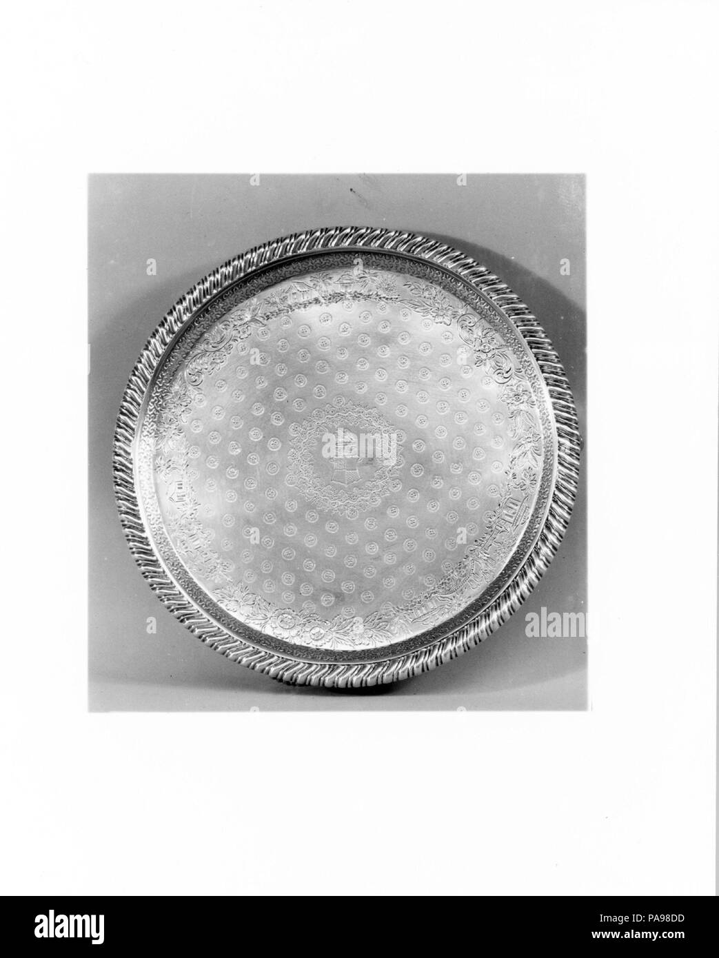 Salver. Culture: American. Dimensions: H. 1 1/4 in. (3.2 cm); Diam. 8 1/8 in. (20.6 cm); 16 oz. 16 dwt. (522.8 g). Maker: Samuel Kirk (1793-1872). Date: ca. 1830.  This small salver would have been used for the presentation of refreshments. Museum: Metropolitan Museum of Art, New York, USA. Stock Photo