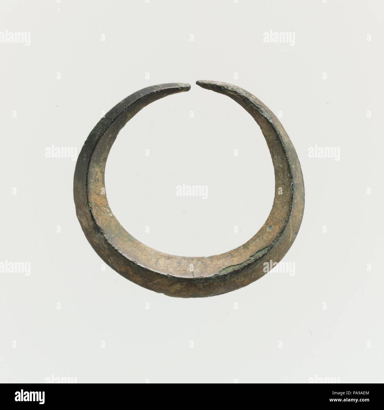 Bronze annular earring. Culture: Minoan. Dimensions: Diameter 7/8 in. (2.1 cm). Date: 2nd millennium B.C..  Bronze hoop earring. Museum: Metropolitan Museum of Art, New York, USA. Stock Photo