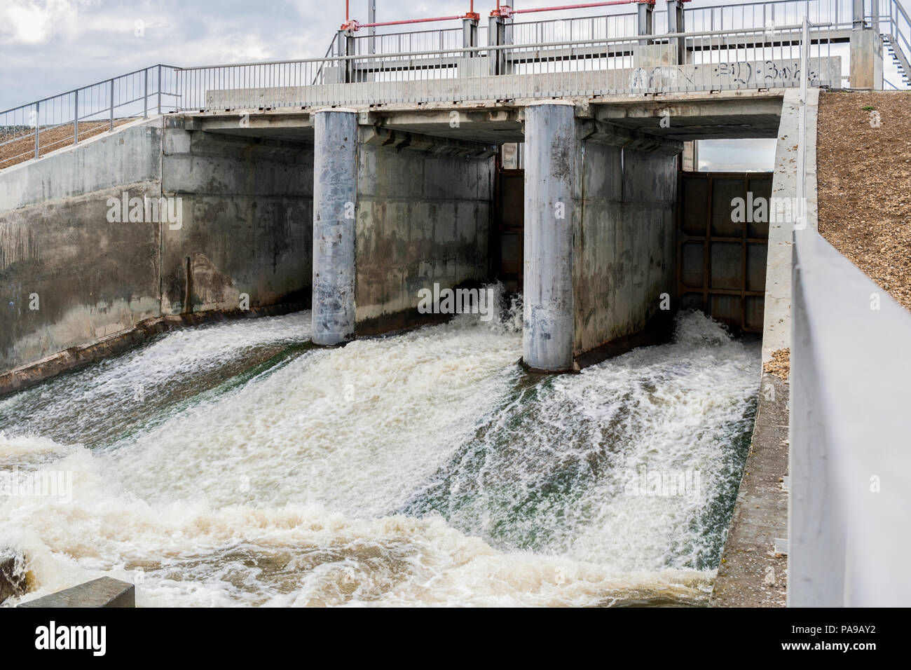 Concrete dam on river with flow of foaming water Stock Photo Alamy
