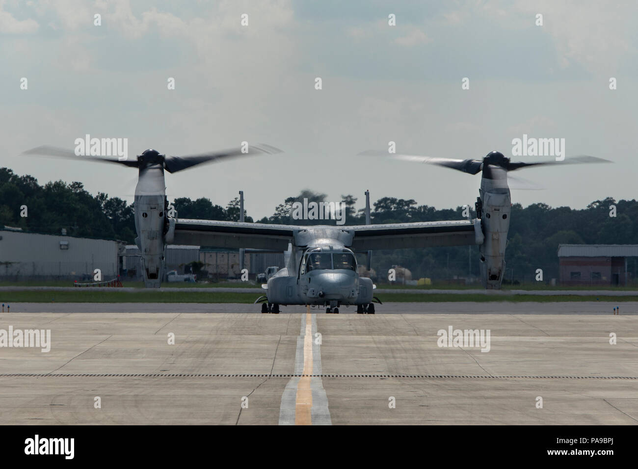 An MV-22 Osprey with Marine Medium Tiltrotor Squadron 264 (Reinforced), 22nd Marine Expeditionary Unit taxis down the flight line at Marine Corps Air Station New River, N.C., July 13, 2018. Contractors worked with Marines to repair corrosion on the aircrafts K-fitting’s, allowing the aircrafts first flight in over two years to take off without a hitch. (U.S. Marine Corps photo by Cpl. Aaron Henson) Stock Photo