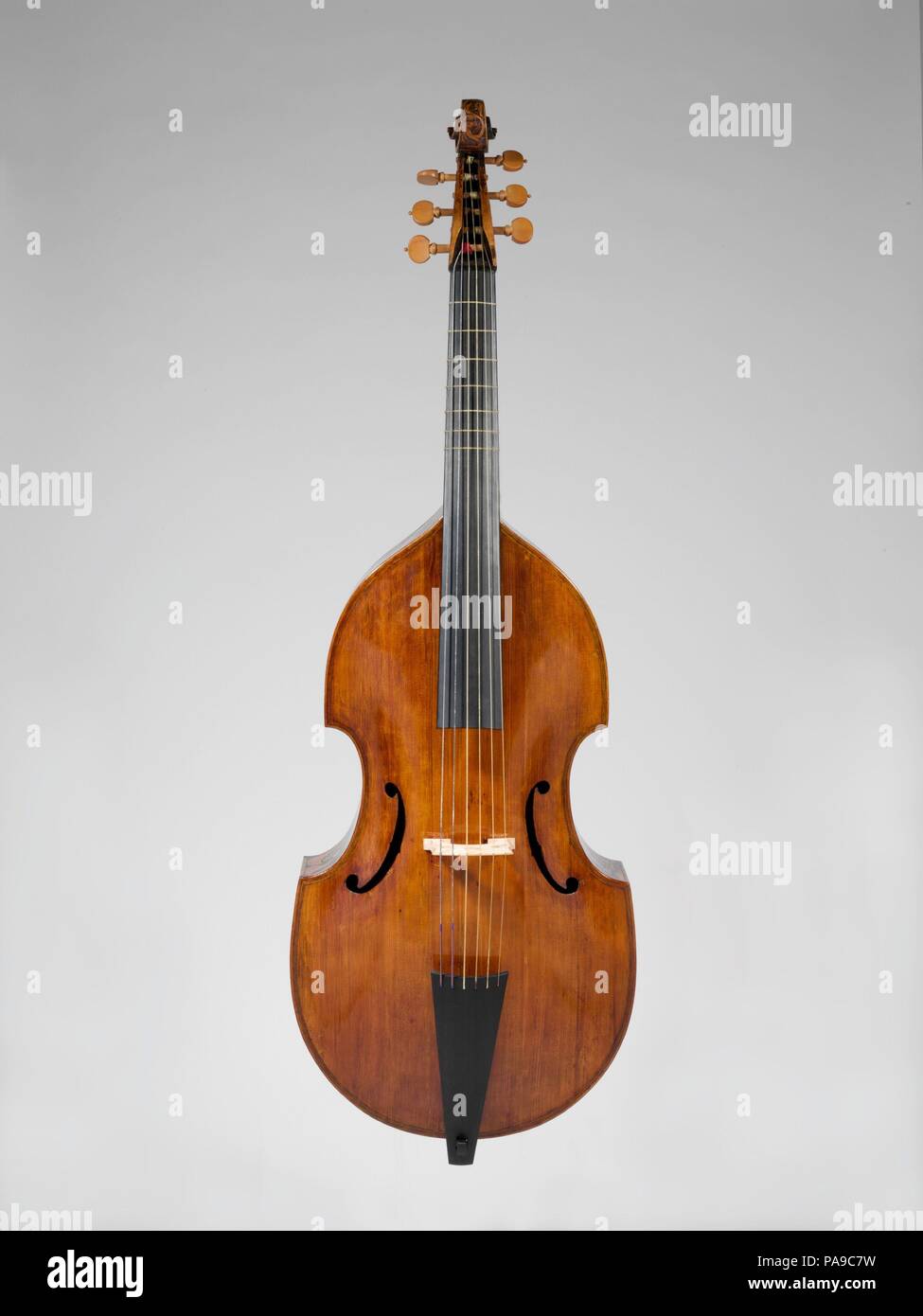 Bass Viola da Gamba. Culture: British. Dimensions: Total L.: 119.5 cm (47-1/16 in.); Body L.: 71.5 cm  (28-3/16 in.); Body W.: upper 32 cm (12-1/2 in.), middle 23.4 cm (9-3/16 in.), lower 39 cm (15-1/8 in.); Rib H.: upper  9 cm (3-5/8 in.), middle 23.4 cm (9-3/16 in.), middle 12.6 cm  (4-15/16 in.); Belly W.: at the neck 5.2 cm (2.05 in.)  lower  39 cm (15.35 in.)lower:  12.7 cm  (5.0 in.)   Belly W. at the neck  5.2 cm (2.05 in.). Former Attribution: John Rose (English, active 1552-61). Date: ca. 1600.  Most surviving viols signed by or attributed to John Rose were likely made by the youn Stock Photo
