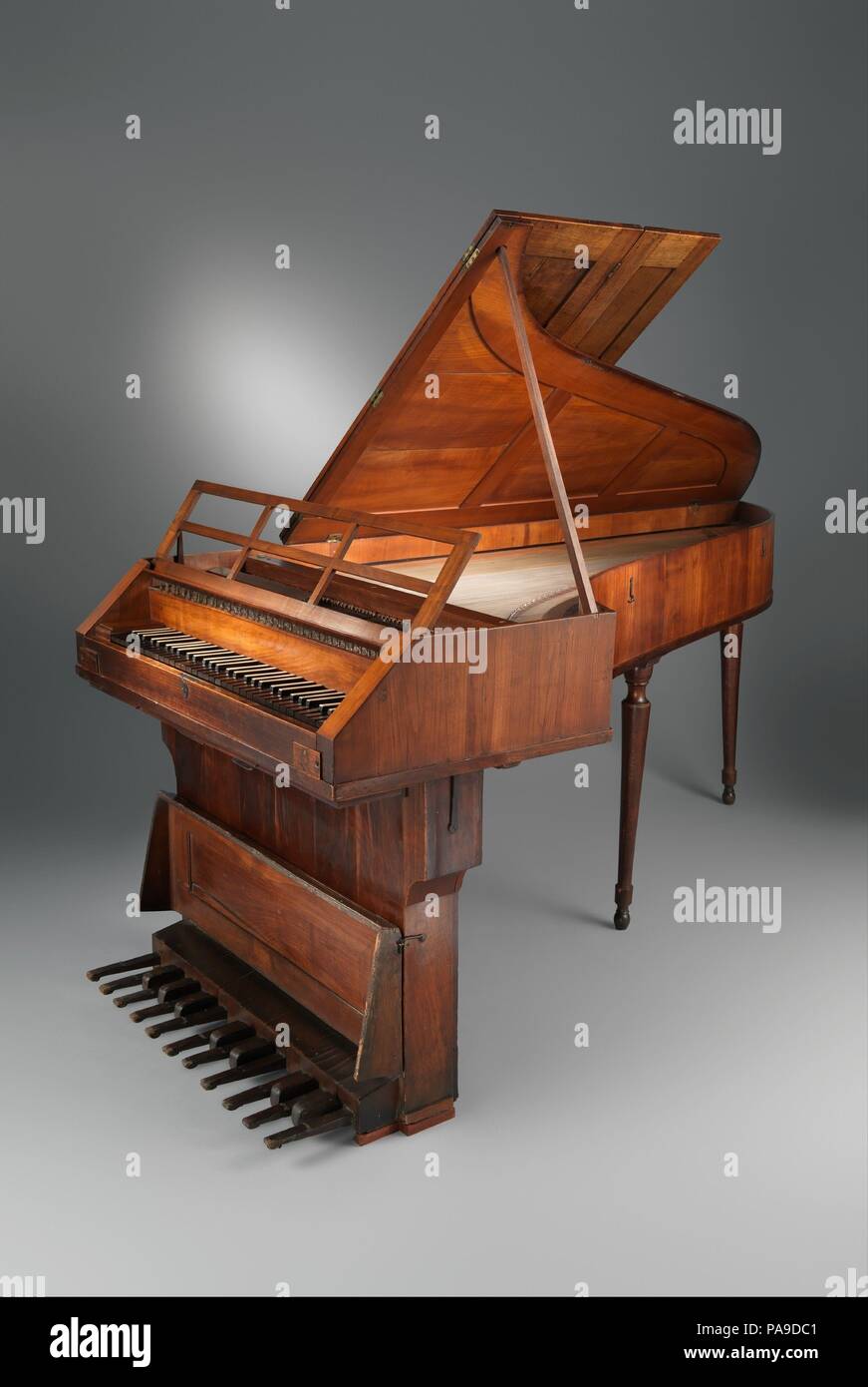 Grand Piano. Culture: Austrian (Salzburg). Dimensions: 36 15/16 × 40 3/16 × 83 7/16 in. (93.8 × 102 × 212 cm)  Height (Total): 36 15/16 in. (93.8 cm)  Width (Of case, parallel to keyboard): 40 3/16 in. (102. cm)  Depth (Of case, perpendicular to keyboard): 83 7/16 in. (212 cm). Maker: Attributed to Johann Schmidt (Austrian 1757-1804). Date: ca. 1790-95.  This extraordinarily rare piano from about 1790 has a pedal board with eighteen notes that are played like pedals on an organ. Pedal stringed-keyboard instruments were not uncommon in the eighteenth century. Johann Sebastian Bach is known to h Stock Photo