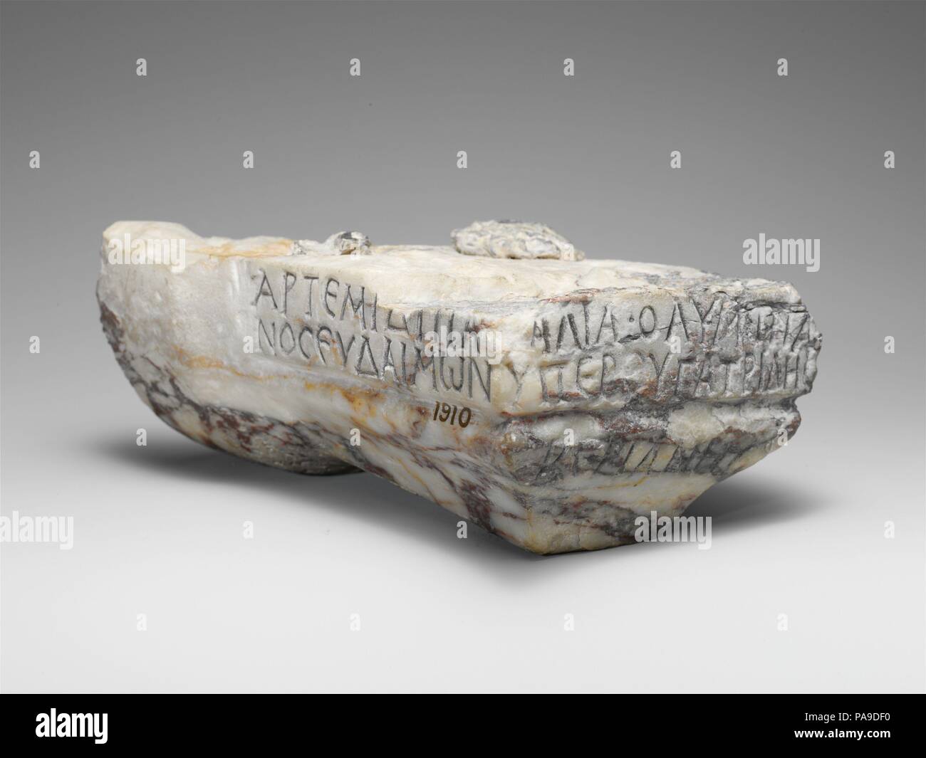 Inscribed marble base. Culture: Roman, Cypriot. Dimensions: Overall: 3 x 7 3/4 x 4 7/8 in. (7.6 x 19.7 x 12.4 cm). Date: 2nd century A.D..  The base or bracket probably supported a small statue of the goddess Artemis Paralia, to whom the inscription is dedicated by a certain Olympianos Eudaimon on behalf of his little sister, Veriane. Museum: Metropolitan Museum of Art, New York, USA. Stock Photo