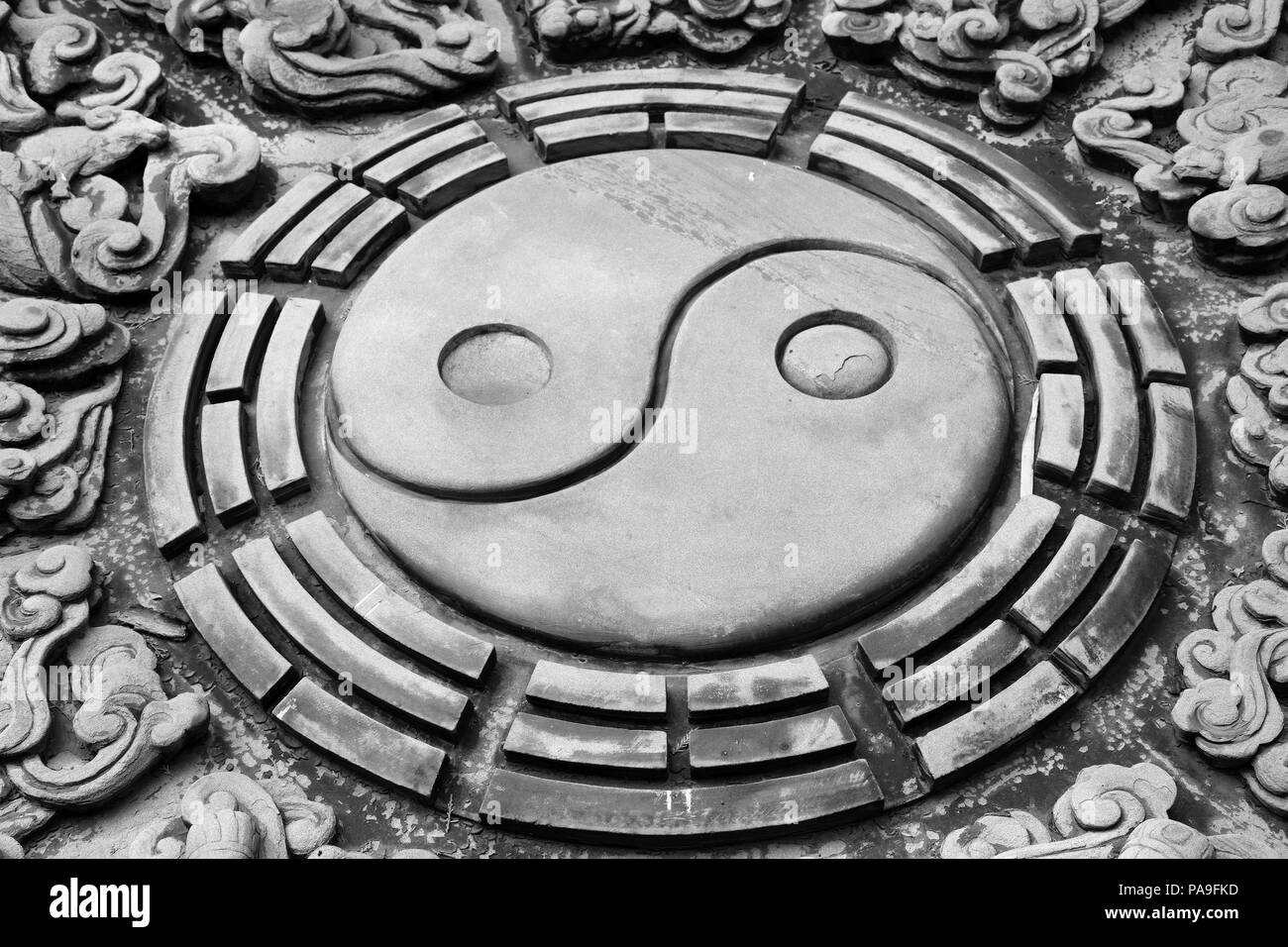 The stone carving of chinese yin yang symbol. Monada. Stock Photo