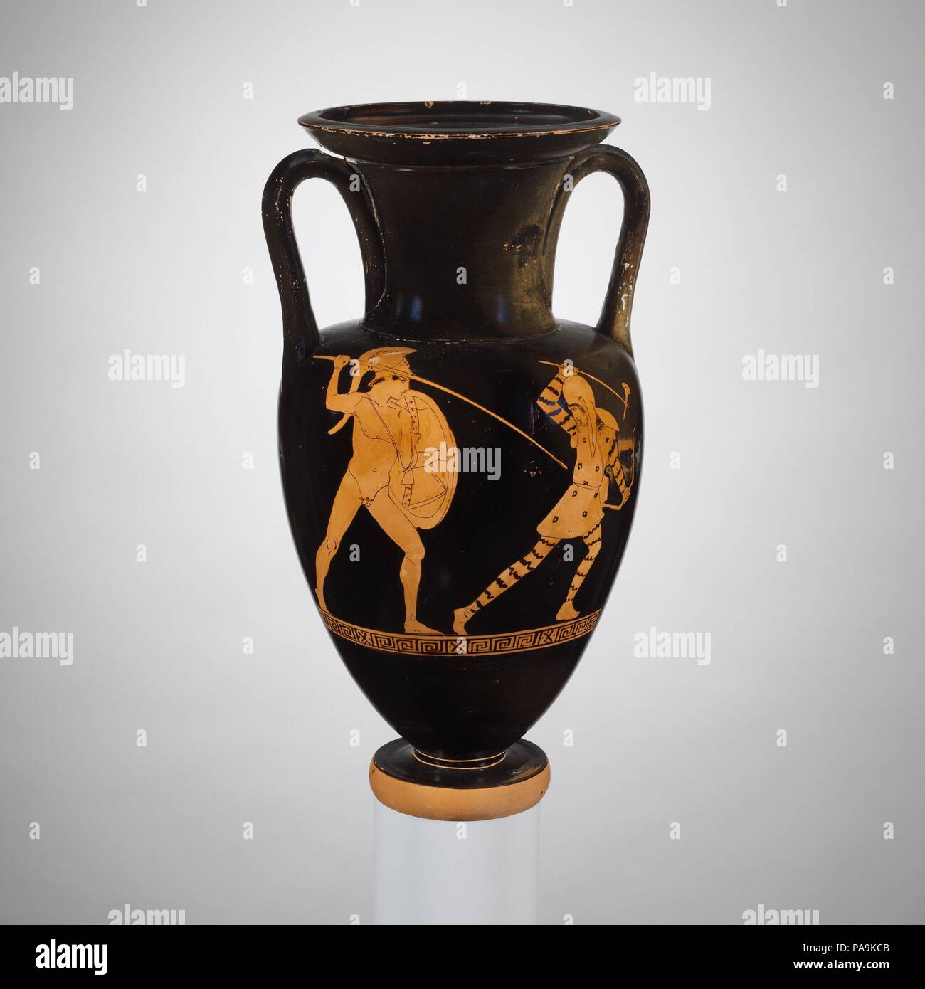 Terracotta Nolan neck-amphora (jar). Culture: Greek, Attic. Dimensions: H. 13 in. (33 cm); diameter of mouth  5 15/16 in. (15.1 cm); diameter of foot  3 1/2 in. (8.9 cm). Date: ca. 440-430 B.C..  Obverse, Greek fighting an Amazon  Reverse, man with staff  The combination of subjects on the obverse and reverse is thought-provoking because one is mythological and the other reflects fifth-century B.C. Athens. In its mythological prehistory, Athens was attacked by the Amazons, a tribe of warrior-women whose homeland lay beyond the Black Sea. Theseus, the legendary king of Attica, fought against th Stock Photo