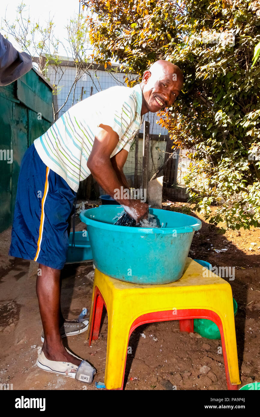 Johannesburg, South Africa, September 11, 2011, Male teacher washing