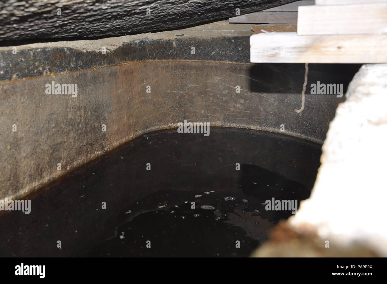 19 July 2018 - Alexandria, Egypt - The black granite sarcophagus uncovered in early July in Alexandria's Sidi Gaber district during foundation work on an apartment building, was opened today by a scientific archaeological committee and they discovered that three skeletons were discovered inside amidst sewage water that had seeped inside.  (MOA pool photo) Stock Photo