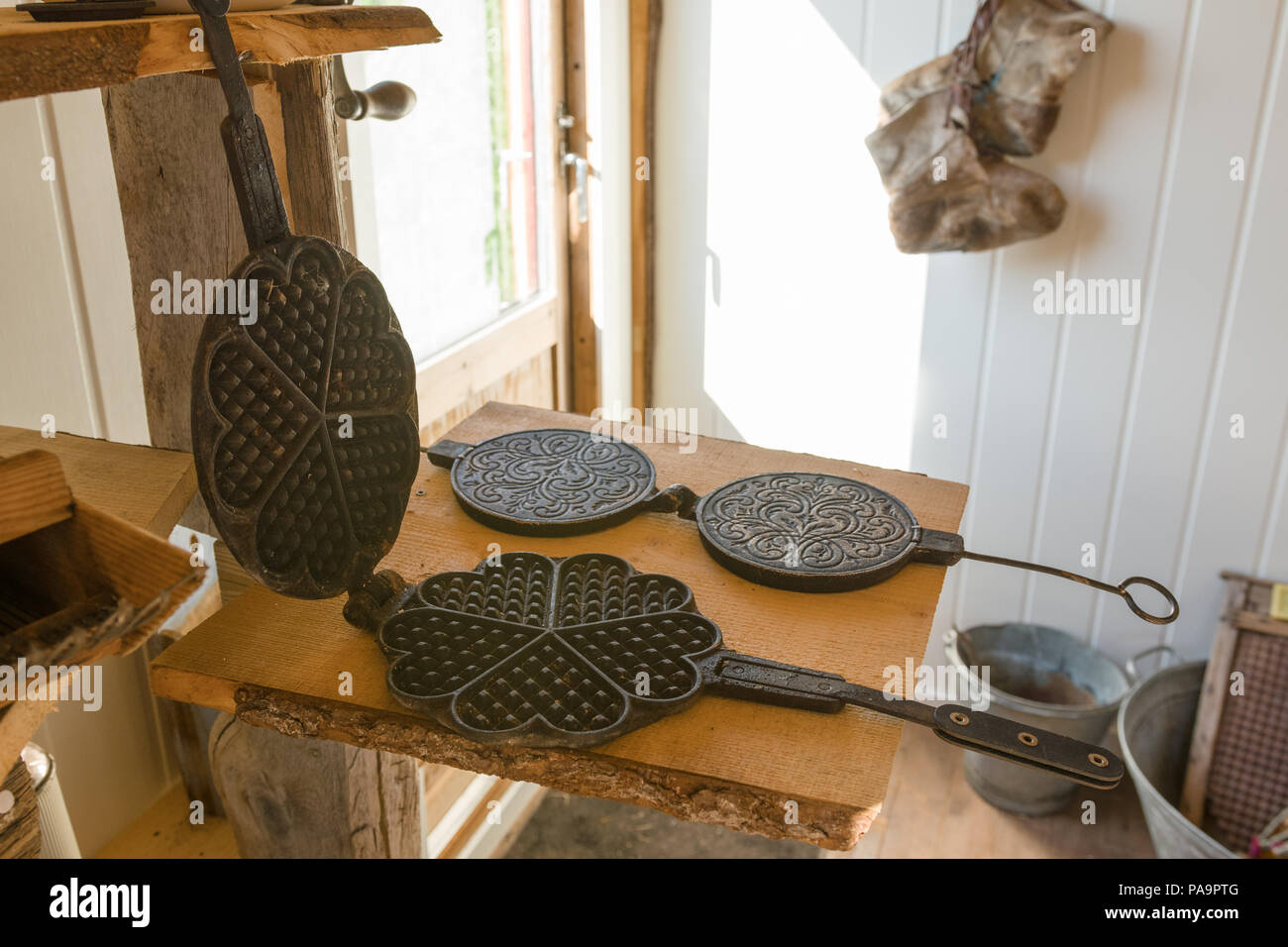 Old waffle iron and bent cake iron at Rural Museum in Smørfjord, Porsanger Stock Photo
