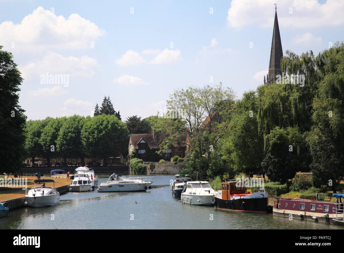 Boats on the River Thames at Abingdon, Oxfordshire UK with St Helen's church in background Stock Photo