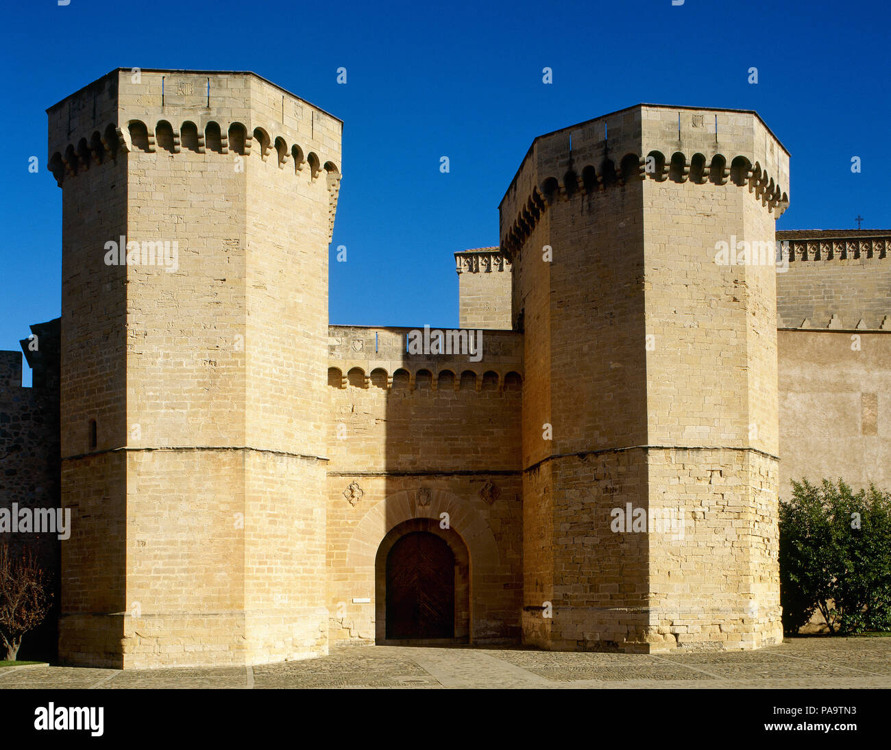Spain, Catalonia, Tarragona province, Vimbodi. The Royal Abbey of Santa Maria de Poblet, a Cistercian monastery. Royal Gate, whose construction was ordered by Peter III el Ceremonios (Peter The Ceremonious, 1319-1387). Gothic style flanked by two octogonal towers. Stock Photo