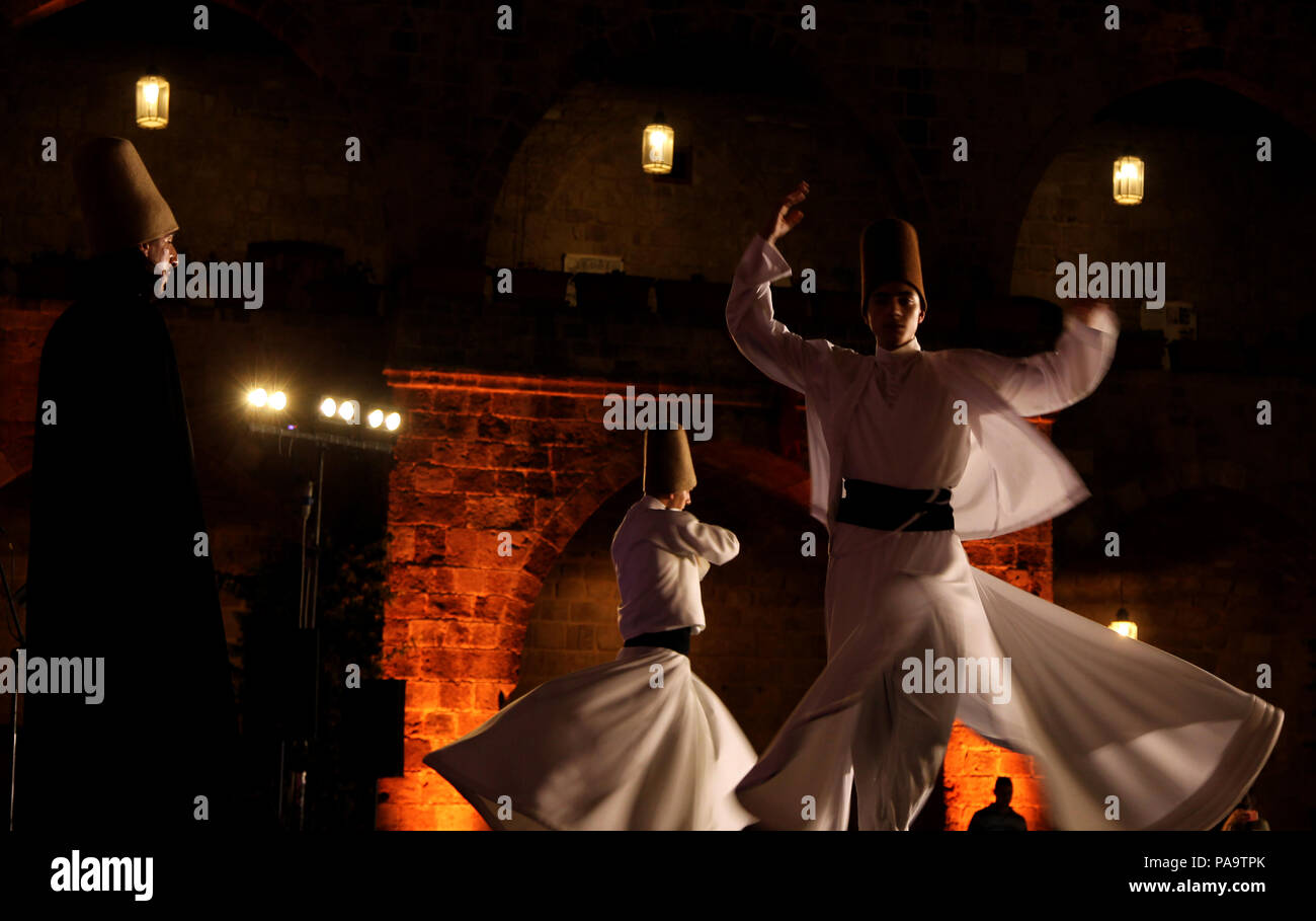 Whirling  dervishes from Turkey perform during the holy month of Ramadan at the historical Khan al-Franj in the southern Lebanese port city of Sidon. Stock Photo