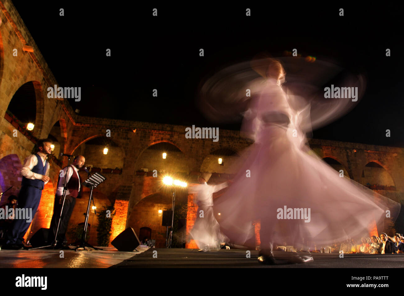 Whirling  dervishes from Turkey perform during the holy month of Ramadan at the historical Khan al-Franj in the southern Lebanese port city of Sidon. Stock Photo