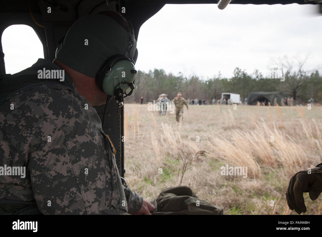 A U.S. Army jumpmaster supervises boarding of paratroopers into a UH-60 ...