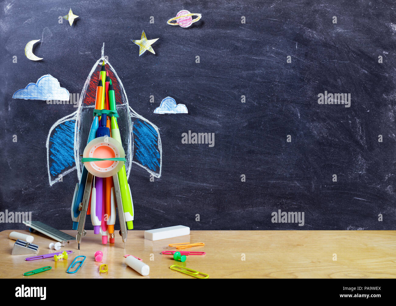 Startup - Rocket Drawing With School Supplies On Table Stock Photo