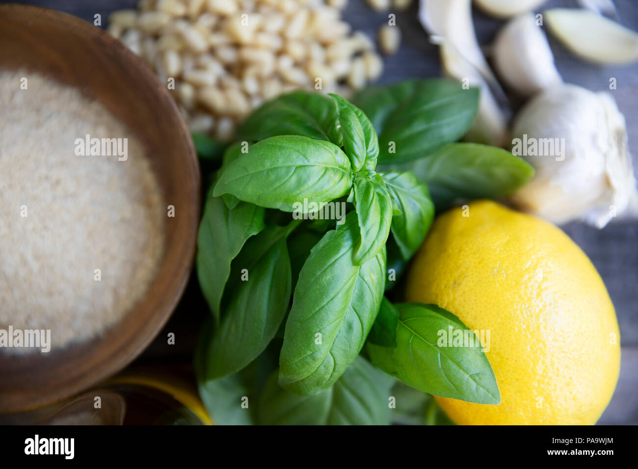 Basil, pine nuts, garlic, lemon, oil and nutritional yeast: ingredients for vegan pesto Stock Photo
