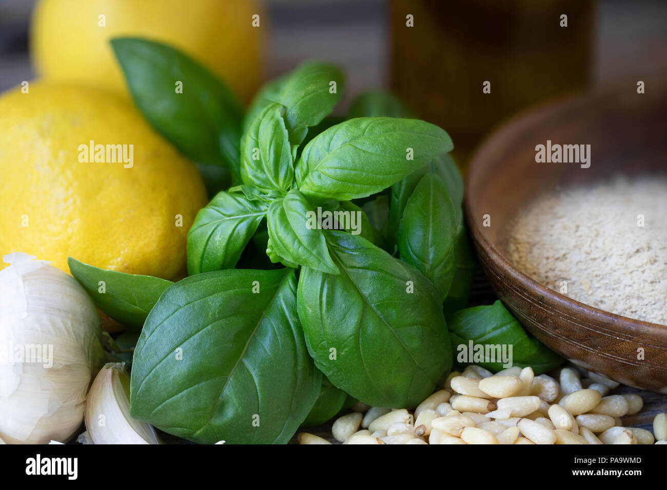 Basil, pine nuts, garlic, lemons and nutritional yeast: ingredients for vegan pesto Stock Photo