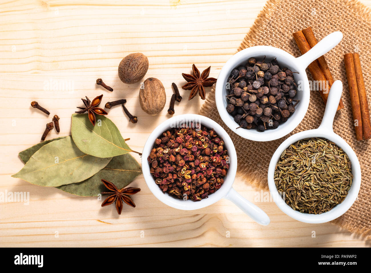 Exotic spices concept Chinese Asian Spices mix  Sichuan peppercorns, star anise pods, bay leave, black peppers, nutmegs, cloves and cinnamon sticks wi Stock Photo
