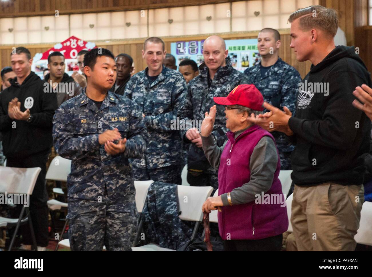 160304-N-RM689-197 GYEONGNAM PROVINCE, Republic of Korea (March 4, 2014) - Sailors and Marines from amphibious dock landing ship USS Ashland (LSD 48) and amphibious dock landing ship USS Germantown (LSD 42) clap to show their appreciation for Imsoon Kim, the founder of Kojedo Aikwangwon Home and School for the Intellectually Disabled during a community relations (COMREL) event. Ashland is assigned to the Bonhomme Richard Expeditionary Strike Group (BHRESG) and is conducting a routine patrol in the U.S. 7th Fleet area of responsibility along with embarked 31st Marine Expeditionary Unit (MEU). ( Stock Photo