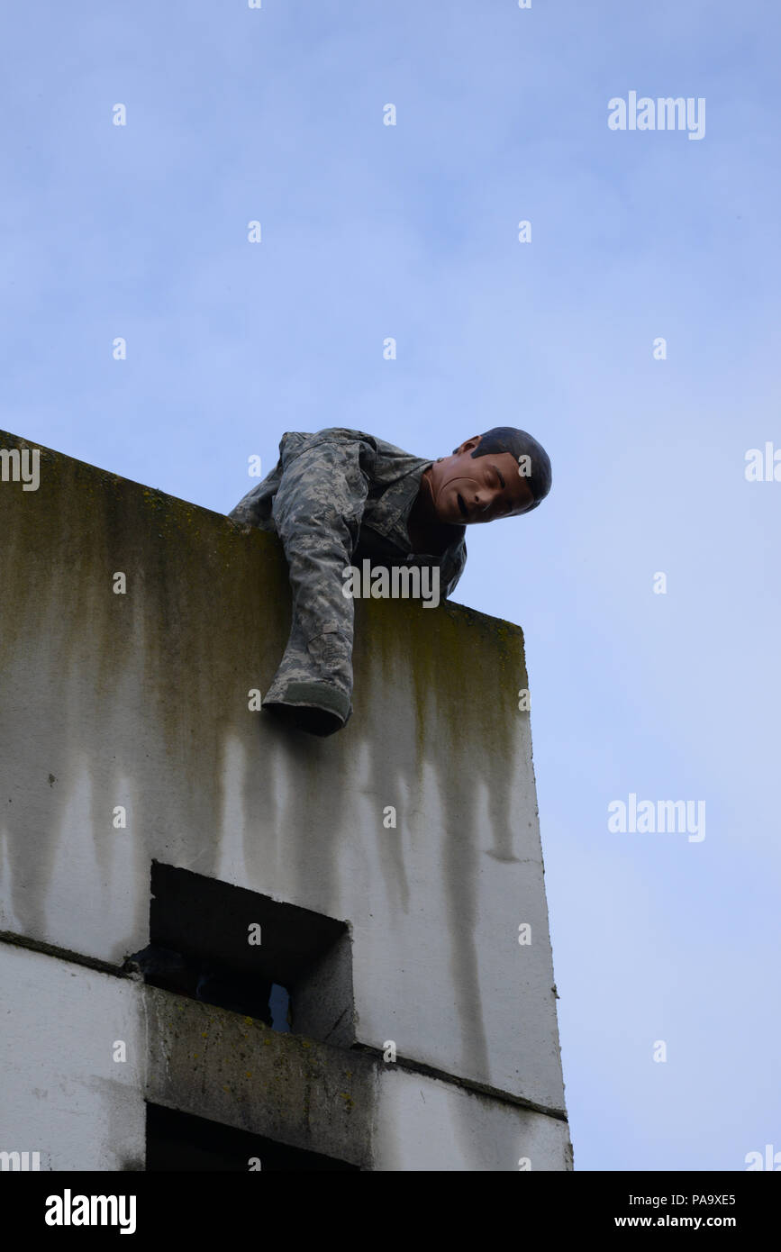 The simulation of a casualty lies on the edge of a roof for one of the practical exercises of the NATO Special Operation Forces (SOF) Campus Technical Exploitation Operations Coordinator Course in the SOF campus in Alliance Training Area on Chièvres Air Base, Chièvres, Belgium, March 3, 2016. (U.S. Army photo by Visual Information Specialist Pascal Demeuldre/Released) Stock Photo