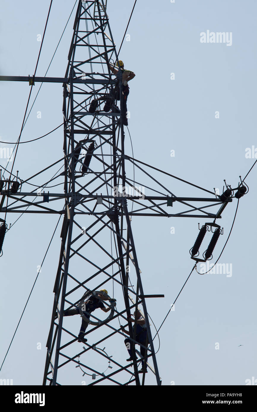 Electrician repair of electric power system. Electrician stays on the