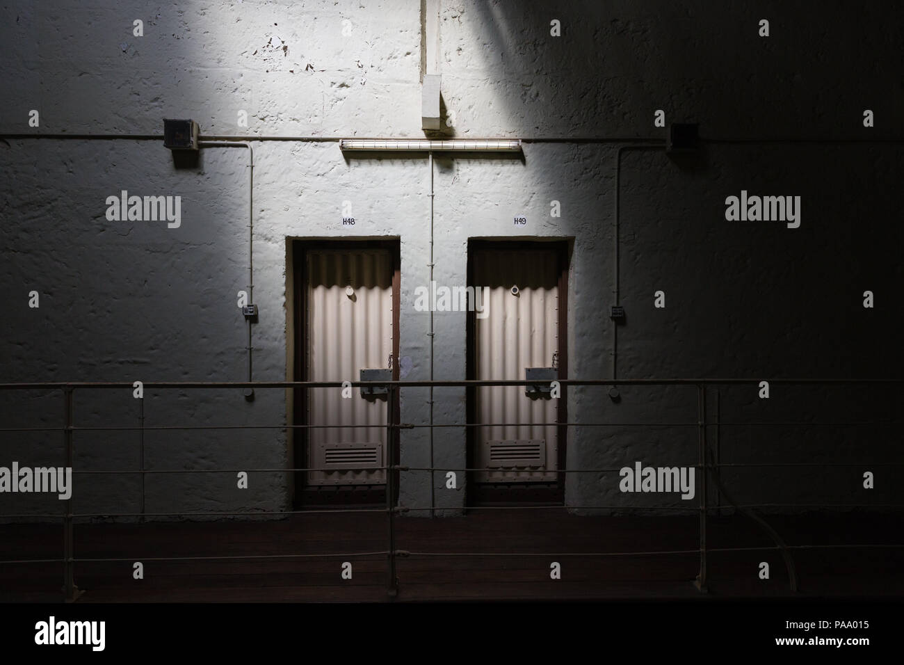 A shaft of sunlight lights up two cell doors on a landing at Freemantle prison, australia. Stock Photo