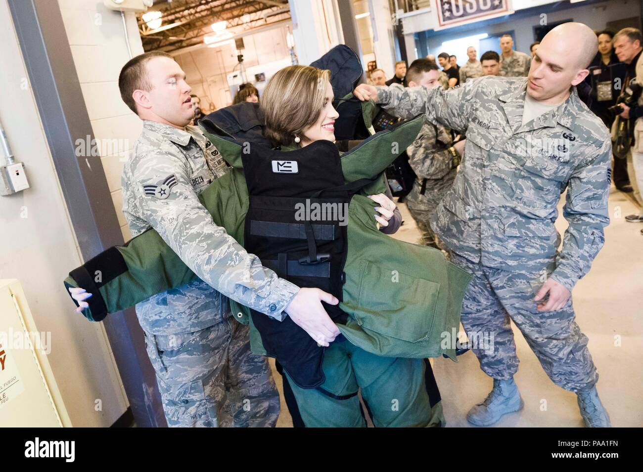 Miss America 2016 Betty Cantrell puts on a bomb suit during a visit to Joint Base Elmendorf-Richardson, Alaska, March 12, 2016. Gen. Selva and country music star Craig Morgan, Miss America 2016 Betty Cantrell, Carolina Panthers cornerback Charles 'Peanut' Tillman, and UFC fighters Donald 'Cowboy' Cerrone and Anthony 'Showtime' Pettis are traveling to seven countries in eight days visiting service members as part of the USO Spring Tour. (DoD photo by U.S. Army Staff Sgt. Sean K. Harp) Stock Photo