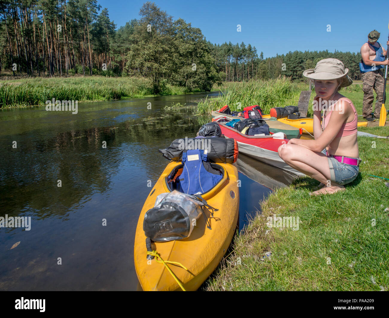River Wda, Poland - August 26, 2016: Kayaker on the bank of the river,  during canoeing excursion on the folding kayak. Bory Tucholskie Stock Photo  - Alamy