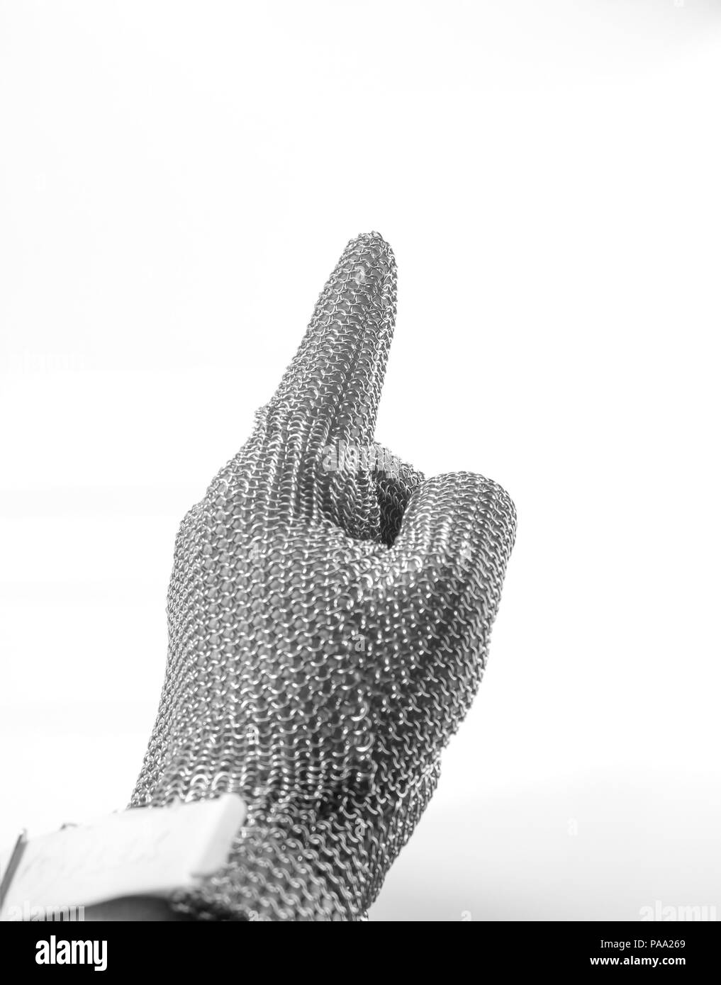 Hand with iron mesh glove on white background. Protection devices for