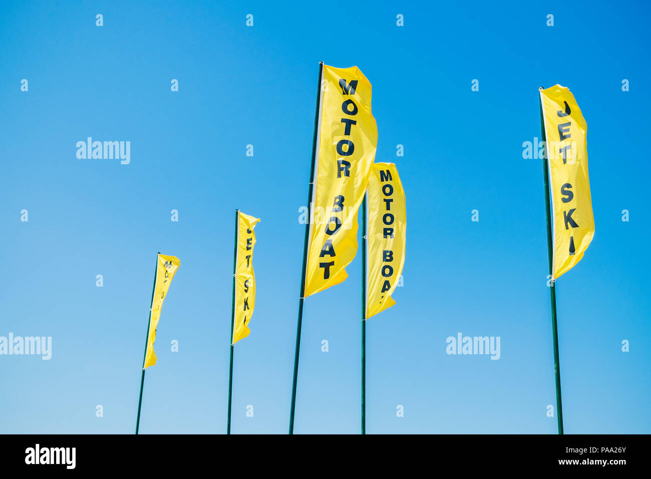 Motor Boat and Jet Ski signs, yellow flag on the beach. Signs for