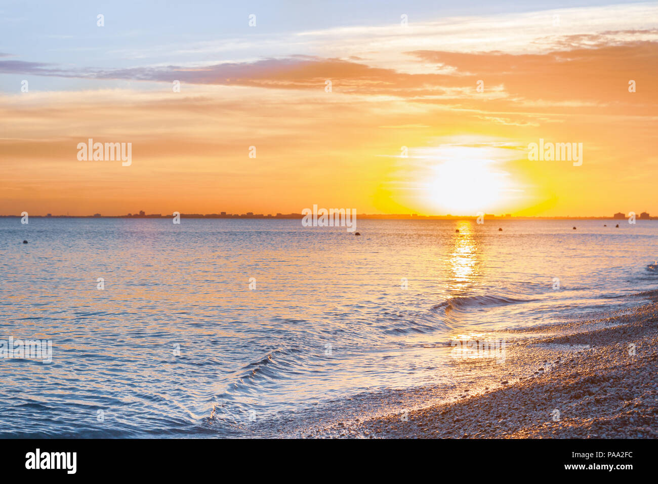 Beautiful summer sunset with clouds over the sea Stock Photo - Alamy