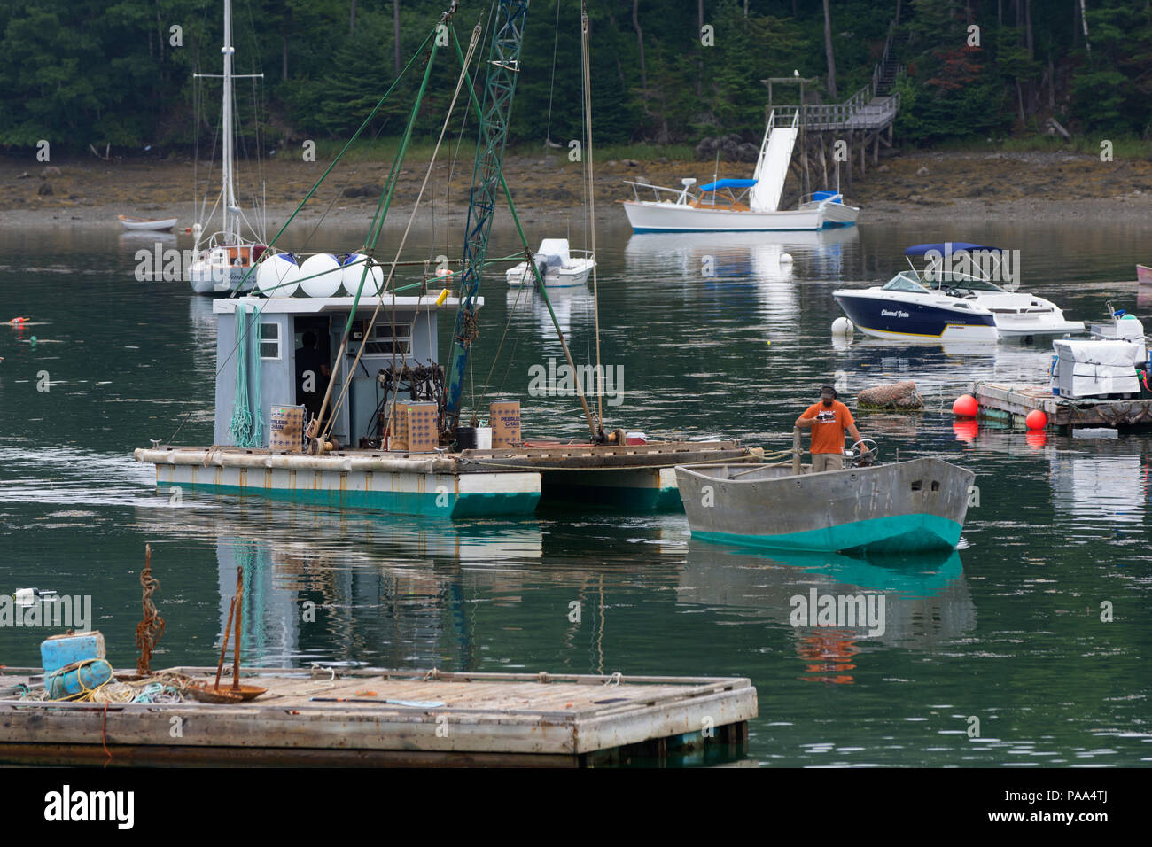 A commercial rig is towed through South Bristol Harbor, Maine, USA Stock Photo