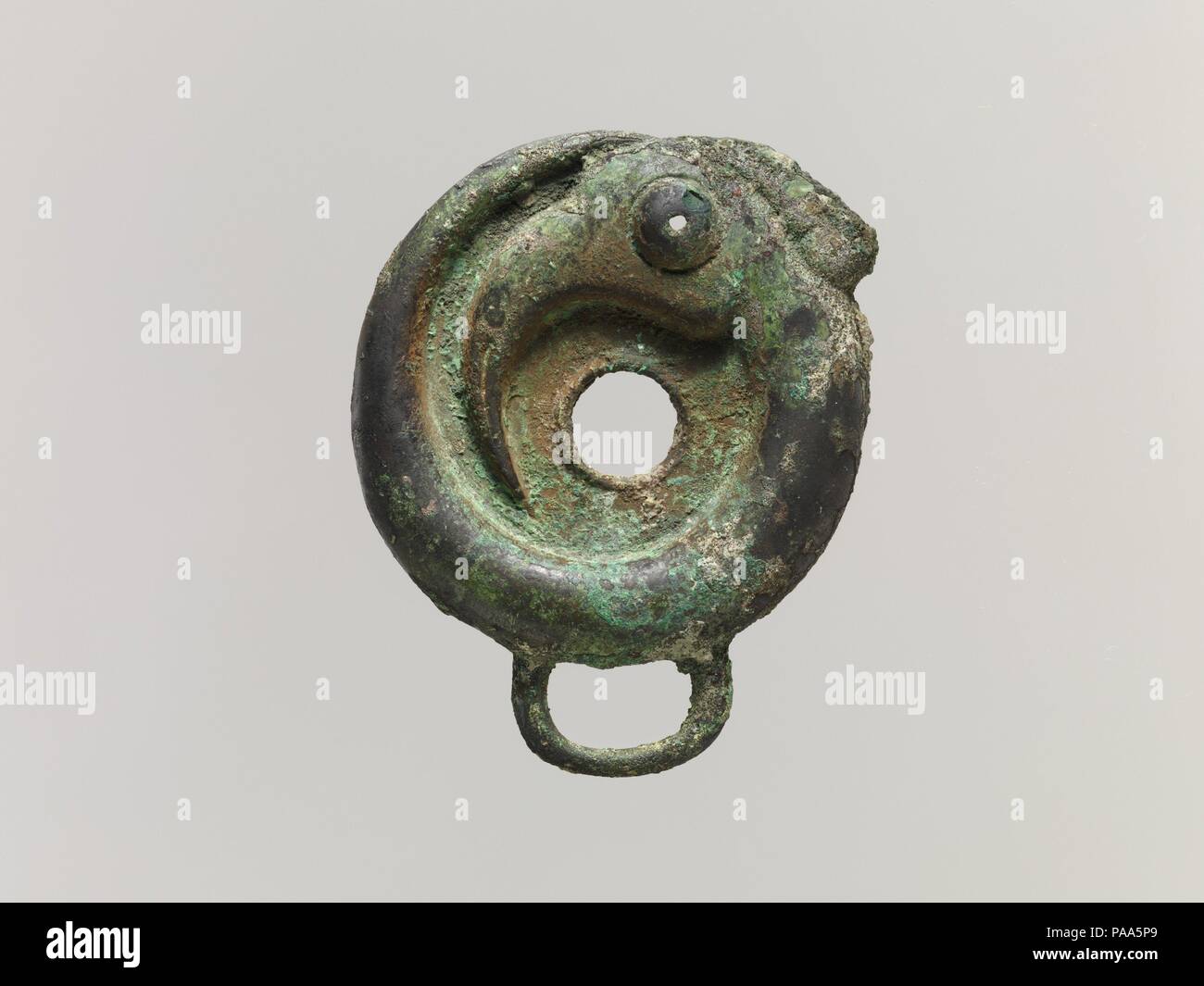 Bridle Cheekpiece. Culture: China. Dimensions: H. 3 3/4 in. (9.5 cm); W. 3 1/16 in. (7.8 cm). Date: 10th-9th century B.C.. Museum: Metropolitan Museum of Art, New York, USA. Stock Photo