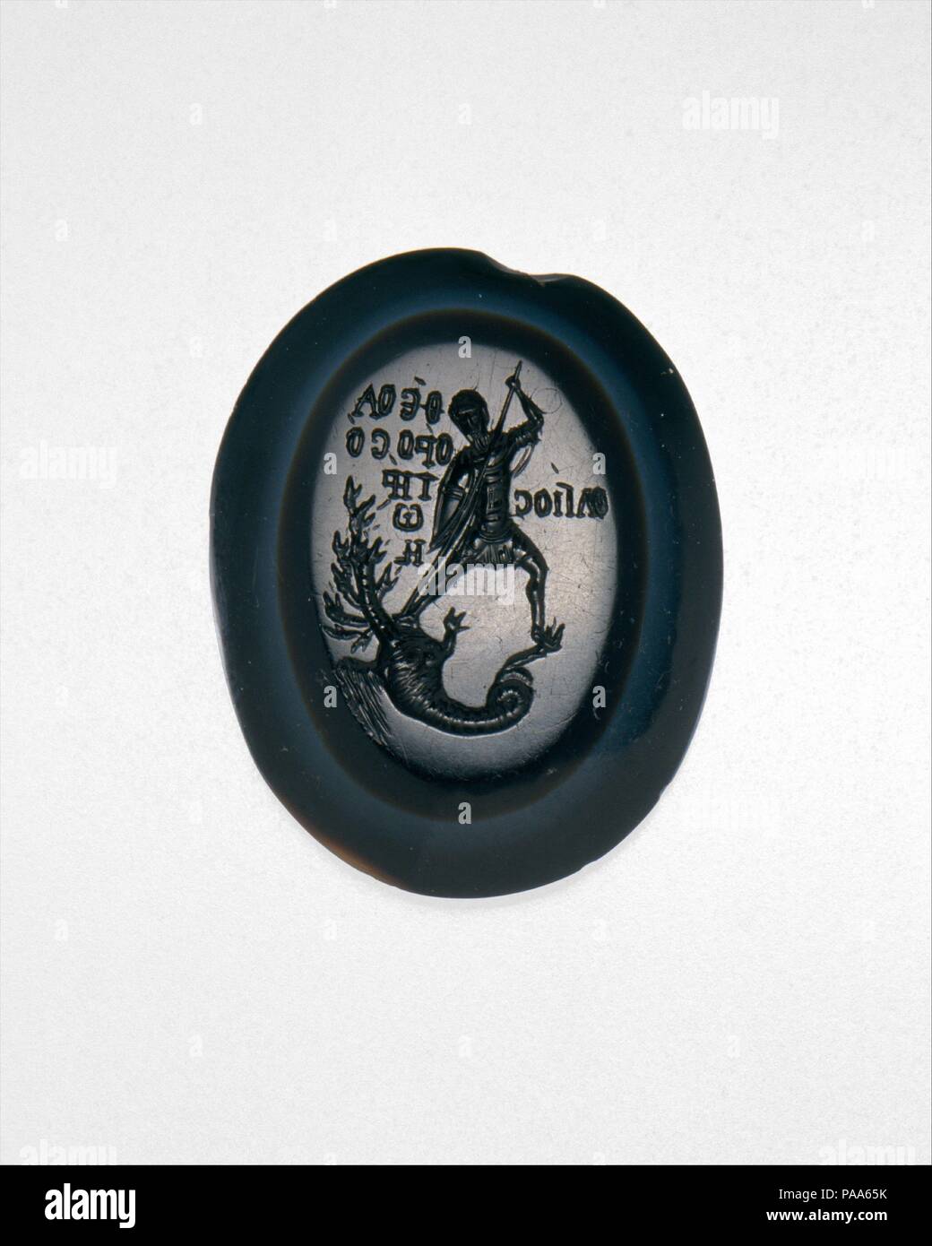 Intaglio with Saint Theodore Teron Slaying a Many-Headed Dragon. Culture: Byzantine. Dimensions: Overall: 1 5/16 x 1 x 1/4in. (3.4 x 2.6 x 0.6cm). Date: 1300 or later.  Theodore Teron (the recruit) was one of several soldier-martyrs whose cults were enormously popular in the later centuries of the Byzantine Empire. This intaglio illustrates Theodore's miraculous slaying of a dragon. The image reflects the revival of classical culture that took place in Byzantium in the 1300s and 1400s; with its naturalistic stance, it recalls classical depictions of Herakles battling the many-headed hydra. Mus Stock Photo