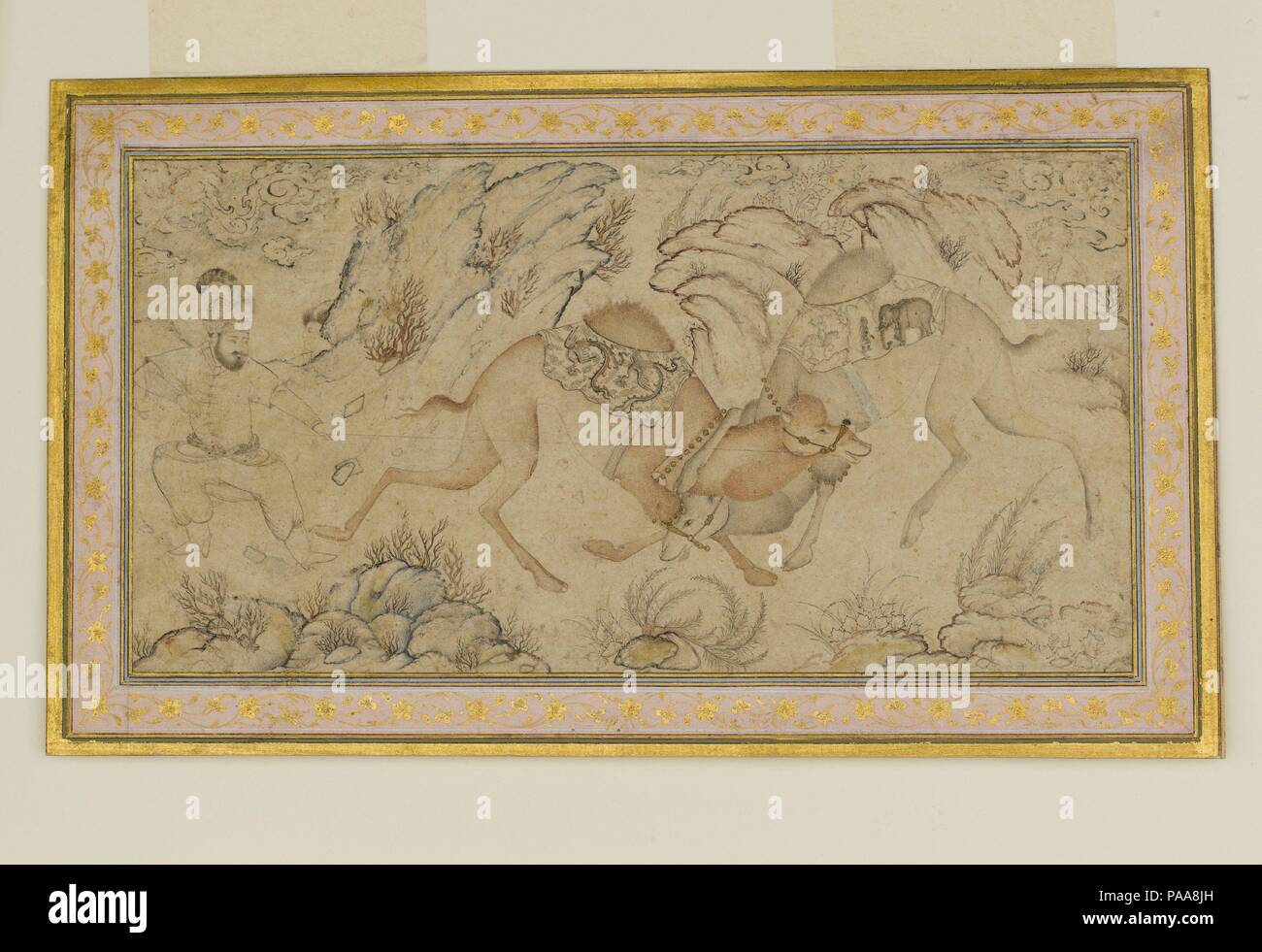 Two Camels Fighting. Dimensions: Painting: H. 4 1/8 in. (10.5 cm)   W. 7 7/8 in. (20 cm)  Page: H. 5 1/2 in. (14 cm)   W. 9 1/4 in. (23.5 cm)  Mat: H. 14 1/4 in. (36.2 cm)   W. 19 1/4 in. (48.9 cm). Date: late 16th-early 17th century.  The depiction of two camels fighting has a long history in Iranian art, stretching back to pre-Islamic times, and was popular in Persian and Mughal painting from the late fifteenth century onward. In this drawing, a man in a cap with a large feather tries to separate one camel from the other. Both camels are draped with ornate saddle blankets, one of which is de Stock Photo