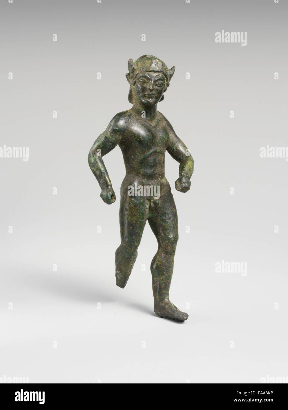 Bronze statuette of a striding warrior. Culture: Etruscan. Dimensions: H.: 4 15/16 in. (12.5 cm). Date: early 5th century B.C..  This striding warrior once held a separately made spear in his right hand and may have carried a shield on his left arm. Museum: Metropolitan Museum of Art, New York, USA. Stock Photo