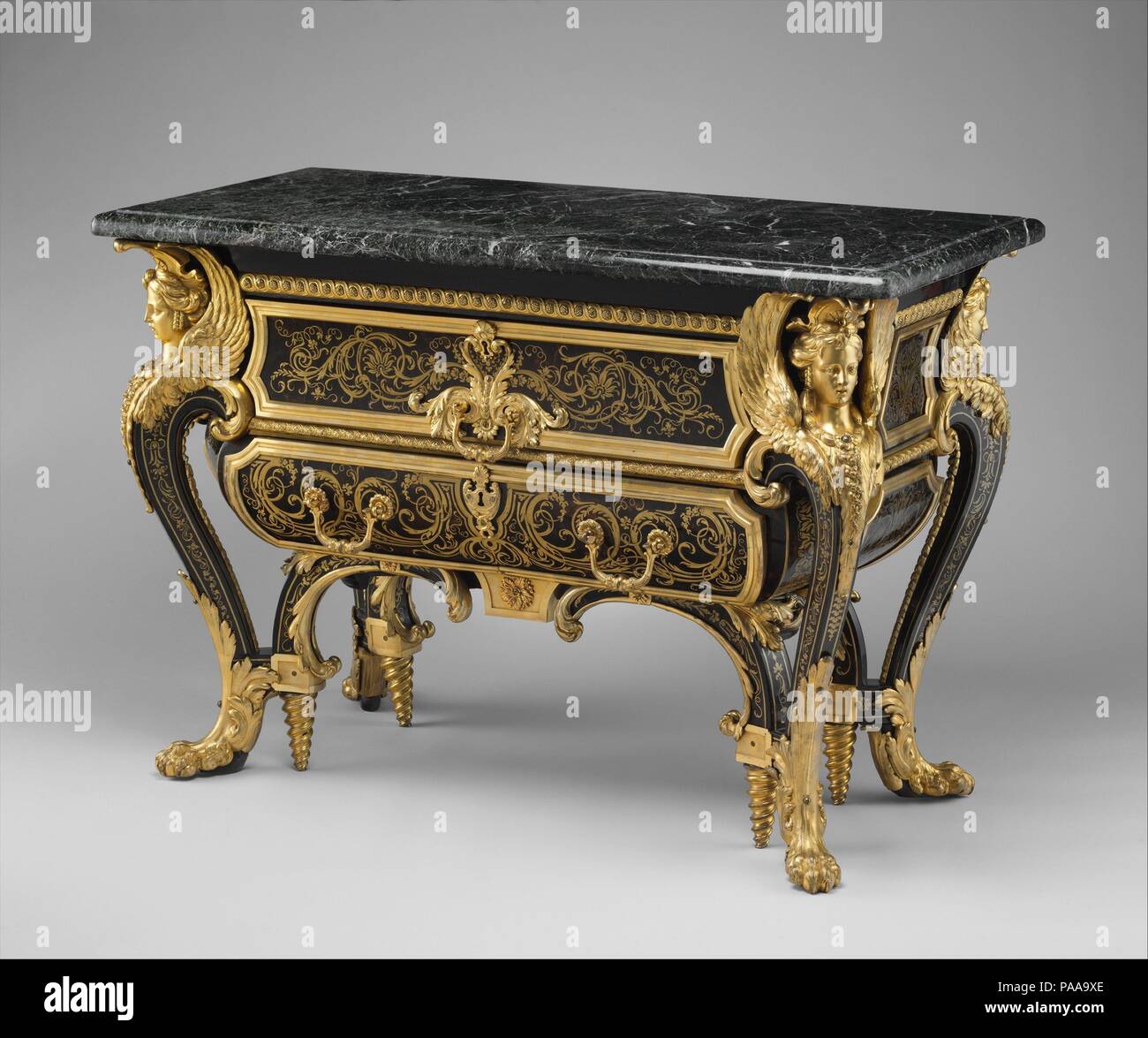 Commode. Culture: French. Dimensions: 34 1/2 × 50 1/2 × 24 3/4 in. (87.6 × 128.3 × 62.9 cm). Maker: André Charles Boulle (French, Paris 1642-1732 Paris). Date: ca. 1710-20.  In 1708, the prototypes for this commode, then called a pair of bureaux, were delivered to the Grand Trianon by André-Charles Boulle. The duc d'Antin, director of the king's buildings, wrote to Louis XIV: 'I was at the Trianon inspecting the second writing desk by Boulle; it is as beautiful as the other and suits the room perfectly.'[1] Not until the Trianon inventory of 1729 were the pieces described as 'commodes.' (They  Stock Photo