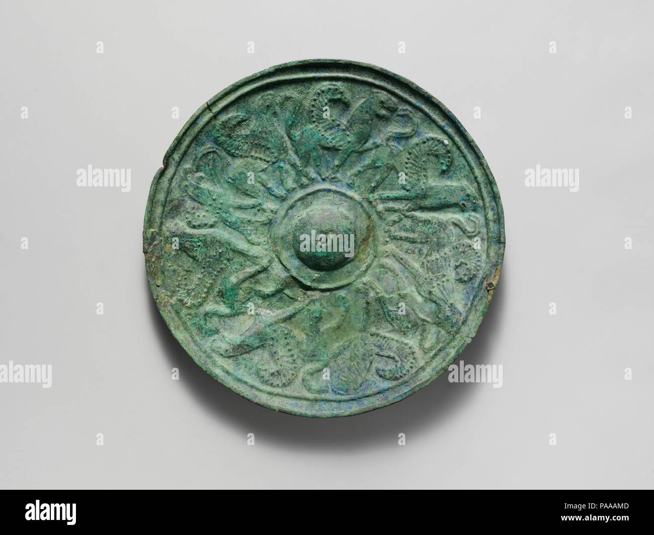 Bronze shield boss with griffin and sphinx frieze. Culture: Etruscan. Dimensions: diameter  4 5/16in. (11cm). Date: ca. 650 B.C..  In repoussé, a procession of winged monsters. Museum: Metropolitan Museum of Art, New York, USA. Stock Photo