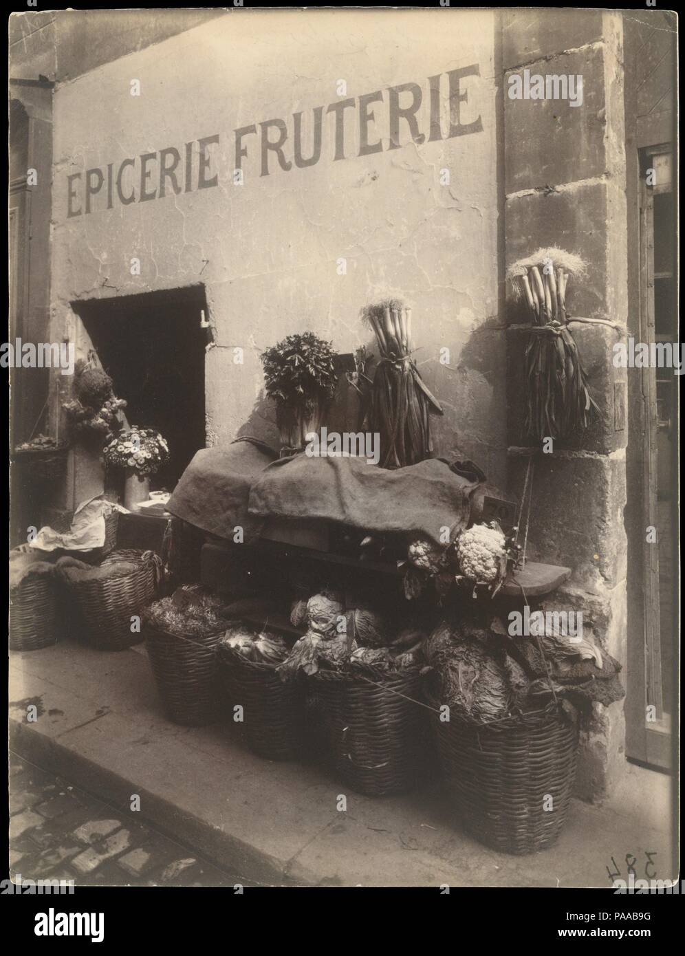 15, rue Maître-Albert. Artist: Eugène Atget (French, Libourne 1857-1927 Paris). Dimensions: 23.2 x 17.6 cm (9 1/8 x 6 15/16 in.). Date: 1912.  Eloquent testimony to Atget's keen regard for the expressions of common folk, this photograph was part of a self-assigned survey of storefronts and commercial signs. Atget ennobled the little grocery with its modest façade and rudimentary display (covered for lunch hour against the midday heat) and framed it simply, thus withdrawing it from the predictable realm of the picturesque. Museum: Metropolitan Museum of Art, New York, USA. Stock Photo