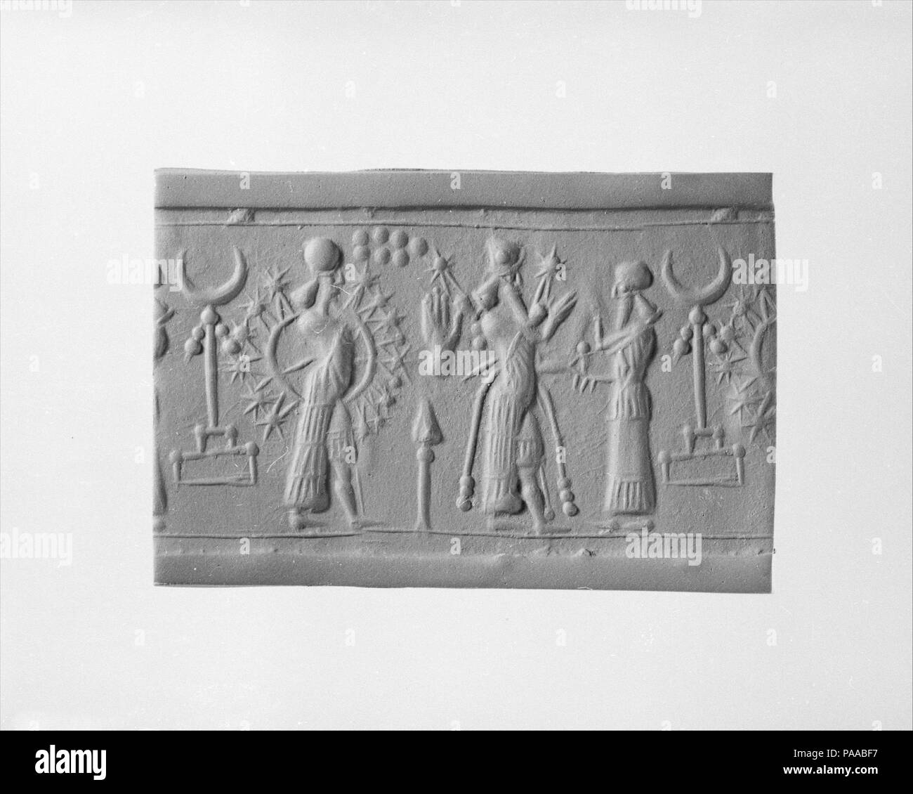 Cylinder seal and modern impression. Culture: Assyrian. Dimensions: 1.36 in. (3.45 cm). Date: ca. 9th-8th century B.C.. Museum: Metropolitan Museum of Art, New York, USA. Stock Photo
