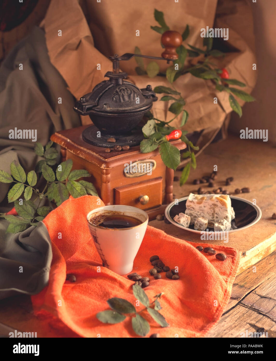 cup of coffee, sweets and grains of coffee on a wooden table Stock Photo