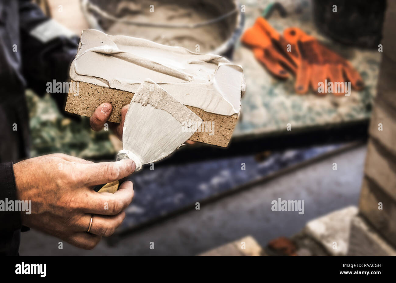 hands with a brick and building trowel Stock Photo