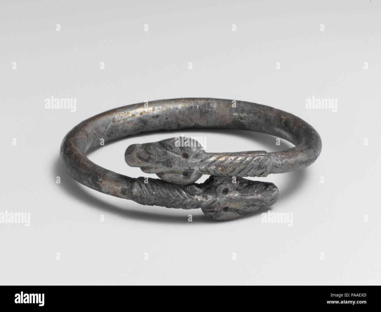 Silver bracelet in the form of a snake. Culture: Roman. Dimensions: Diameter: 1 7/8 in., 0.9oz. (4.8 cm, 26.7g). Date: 3rd century A.D..  Bracelet terminating in snakes' heads. Museum: Metropolitan Museum of Art, New York, USA. Stock Photo