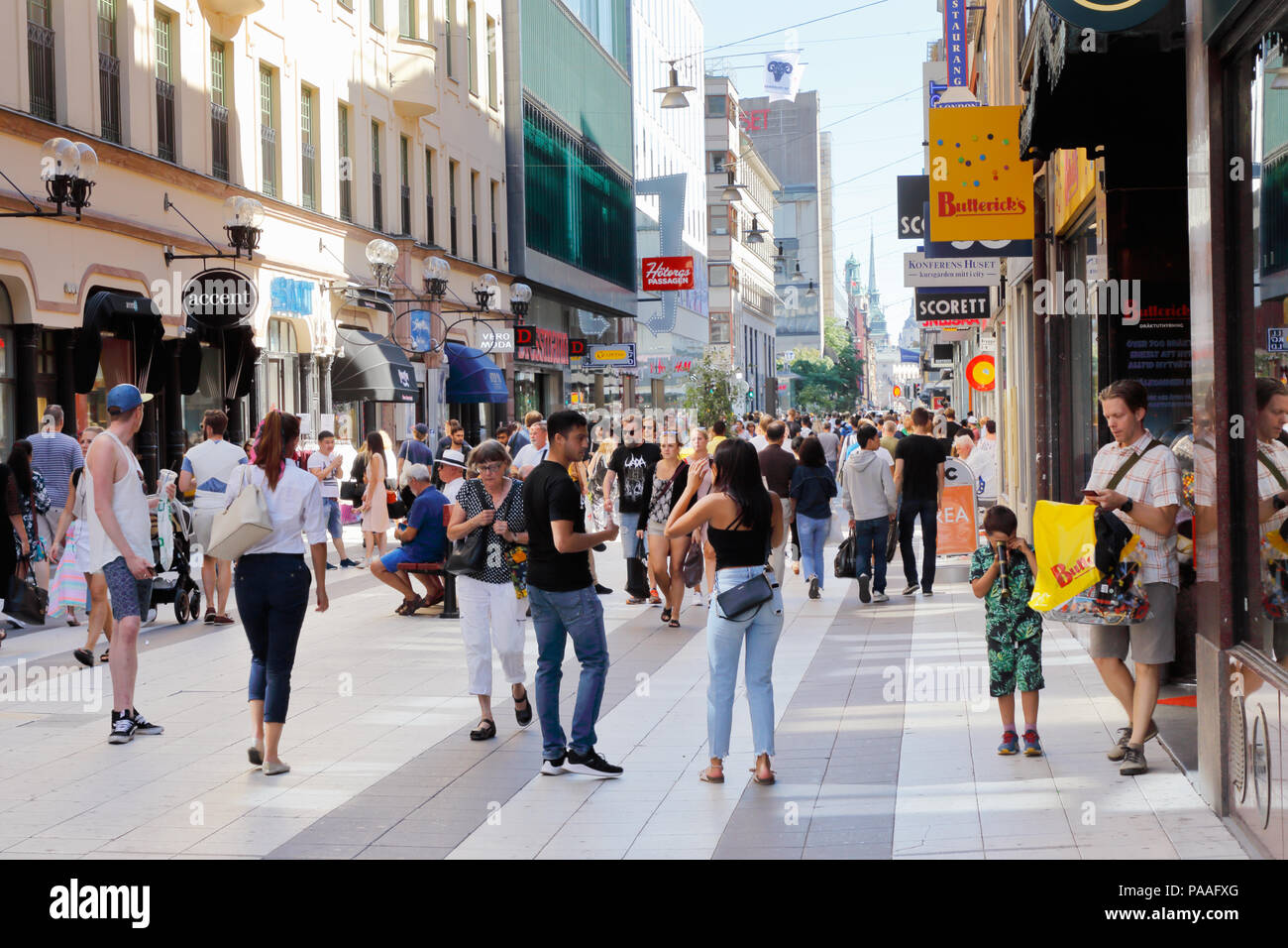 Stockholm, Sweden - July 12, 2018: View of people at the shopping pedestrian only street Drottninggatan in the downtown district. Stock Photo