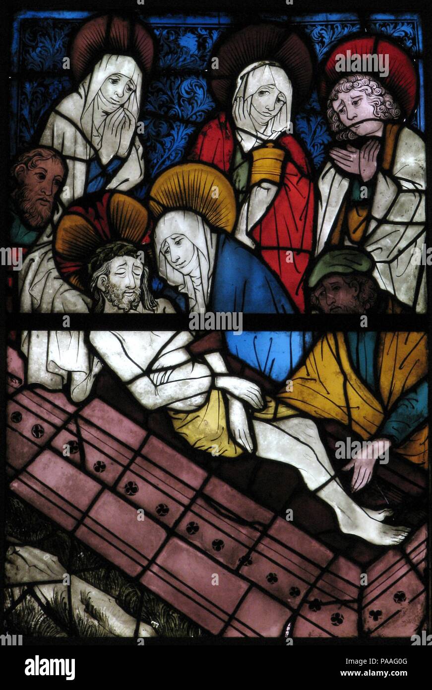 Stained Glass Panel with the Entombment. Culture: German. Dimensions: Overall (with 1 T-bar): 43 1/2 x 29 7/8 x 3/8 in. (110.5 x 75.9 x 1 cm)  Overall (installation opening): 41 3/4 x 28 3/8 in. (106 x 72.1 cm)  a: 21 13/16 x 29 3/8 x 3/8 in. (55.4 x 74.6 x 1 cm)  b: 21 9/16 x 29 1/8 x 3/8 in. (54.8 x 74 x 1 cm). Date: 15th century.  These panels were part of a window depicting the ancestry of Christ in the form of a Tree of Jesse (a complete example is shown opposite).  The painter of these windows adopted an angular style of drapery folds and subtle color juxtapositions initiating a new styl Stock Photo