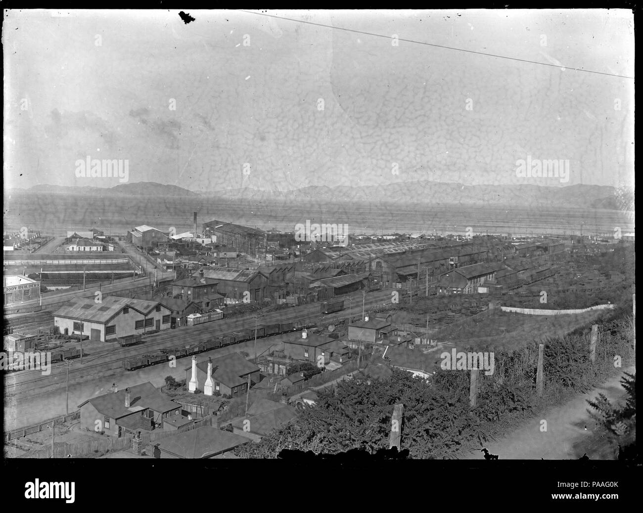 197 Petone Railway Workshops, with Wellington Harbour and Somes Island in the background, from Korokoro. ATLIB 283555 Stock Photo