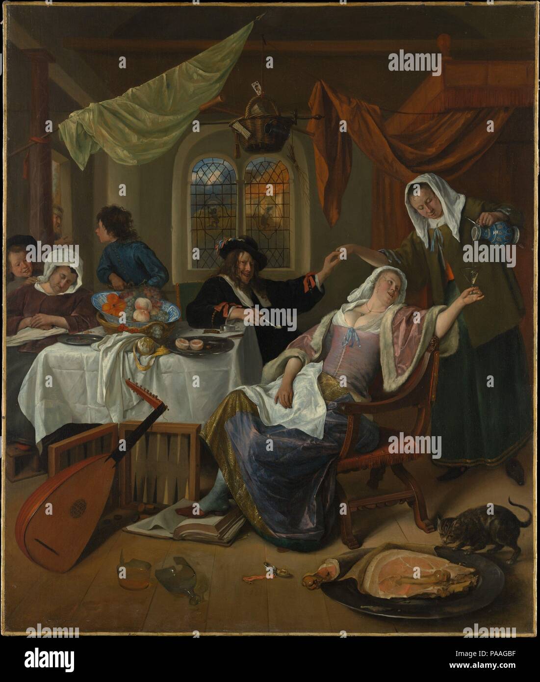 The Dissolute Household. Artist: Jan Steen (Dutch, Leiden 1626-1679 Leiden). Dimensions: 42 1/2 x 35 1/2 in. (108 x 90.2 cm). Date: ca. 1663-64.  Steen and members of his family modeled for this scene of domestic chaos, which is still called a 'Jan Steen Household' in The Netherlands. The company acts out a variety of familiar sins, such as Sloth, Gluttony, Lust (papa and the maid), and other offences--a Bible is trampled, and a beggar is repelled at the door--all heedless of the open watch, suggesting temperance, and the basket hanging like Fate over their heads (the objects in it promise pov Stock Photo