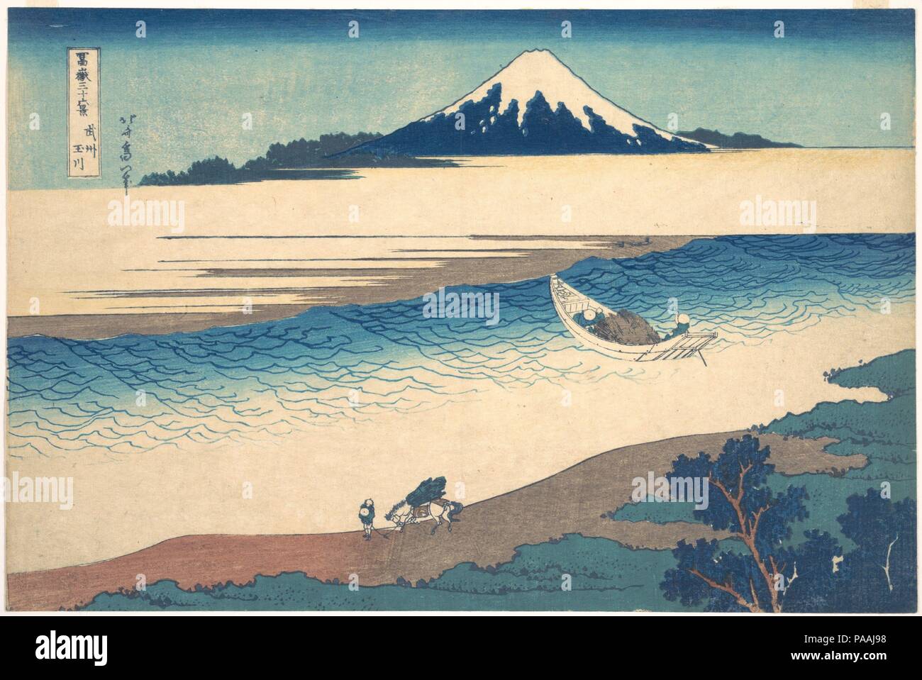 Tama River in Musashi Province (Bushu Tamagawa), from the series Thirty-six Views of Mount Fuji (Fugaku sanjurokkei). Artist: Katsushika Hokusai (Japanese, Tokyo (Edo) 1760-1849 Tokyo (Edo)). Culture: Japan. Dimensions: 9 7/8 x 14 7/8 in. (25.1 x 37.8 cm). Date: ca. 1830-32.  On the clear waters of the Tama River sails a small ferryboat carrying branches and twigs. Its movement into the depths of the print guides the viewer's eye toward the sacred mountain rising in the distance. Fuji's deep blue coloration matches that of the trees on the near coast, creating a formal link between background  Stock Photo